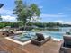 Luxury backyard with a pool, hot tub, and lounge chairs overlooking a beautiful lake view at 2775 Club Valley Ct, Jonesboro, GA 30236