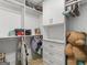 Bright walk-in closet featuring built-in shelves and drawers at 2775 Club Valley Ct, Jonesboro, GA 30236