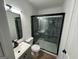 Modern bathroom with a glass-enclosed shower, sleek fixtures, and wood-look flooring at 437 Collier Ridge Nw Dr, Atlanta, GA 30318