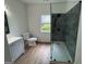 Bathroom with modern gray shower, updated fixtures, toilet, and vanity at 437 Collier Ridge Nw Dr, Atlanta, GA 30318
