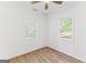 Bedroom featuring hardwood floors, a ceiling fan, and natural light through two windows at 437 Collier Ridge Nw Dr, Atlanta, GA 30318