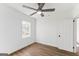 A modern bedroom with wood-look floors, a ceiling fan, and a large window at 437 Collier Ridge Nw Dr, Atlanta, GA 30318