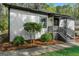 A view of the front exterior showcasing the landscaped yard and gray stairs leading up to the front door at 437 Collier Ridge Nw Dr, Atlanta, GA 30318