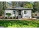 Charming single-story home featuring a well-manicured lawn and gray siding with a black roof at 437 Collier Ridge Nw Dr, Atlanta, GA 30318
