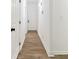 Hallway with white walls and doors plus attractive and modern hardwood floors at 437 Collier Ridge Nw Dr, Atlanta, GA 30318