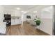 An open kitchen, complete with white cabinets and wood-look flooring. Adjacent to the living room at 437 Collier Ridge Nw Dr, Atlanta, GA 30318