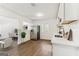 Well-lit kitchen with stainless steel appliances, white cabinets, and wood-look flooring; view to living area at 437 Collier Ridge Nw Dr, Atlanta, GA 30318