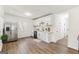 Well-lit kitchen featuring stainless steel appliances, white cabinets, and wood-look flooring at 437 Collier Ridge Nw Dr, Atlanta, GA 30318