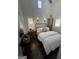Charming bedroom featuring white wood walls, a comfortable bed, classic decor, and soft, natural lighting at 155 Central Ave, Fayetteville, GA 30214