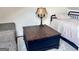 Bedroom features a wooden storage ottoman that doubles as a coffee table and a gray sofa at 155 Central Ave, Fayetteville, GA 30214