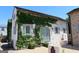 Charming white brick home with light blue shutters and climbing vines creating a picturesque facade at 155 Central Ave, Fayetteville, GA 30214