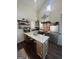 Modern kitchen with stainless steel appliances, a central island with bar seating, and stylish floating shelves at 155 Central Ave, Fayetteville, GA 30214