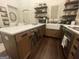 Bright kitchen featuring a farmhouse sink, a center island with bar stools, and open shelving with elegant decor at 155 Central Ave, Fayetteville, GA 30214