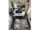 Aerial view of a modern kitchen with an island, stainless steel appliances, and an adjacent seating area at 155 Central Ave, Fayetteville, GA 30214