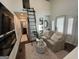 Inviting living room with a comfortable seating area, a tall ladder leading to a loft, and elegant decor at 155 Central Ave, Fayetteville, GA 30214