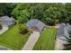 Aerial view of a charming home with a well-maintained lawn and mature trees providing shade at 3511 Cherry Blossom Ct, Loganville, GA 30052