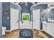 Primary bathroom features separate vanities, soaking tub with window, and private toilet area at 3511 Cherry Blossom Ct, Loganville, GA 30052