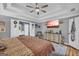Serene bedroom featuring a trey ceiling, ceiling fan, sitting area, and private ensuite bathroom at 3511 Cherry Blossom Ct, Loganville, GA 30052