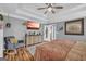 Tranquil bedroom with trey ceiling, ceiling fan, wood floors, sitting area, and ensuite bath access at 3511 Cherry Blossom Ct, Loganville, GA 30052