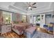 Relaxing bedroom features trey ceilings, fan, wood floors, and access to a private bath at 3511 Cherry Blossom Ct, Loganville, GA 30052