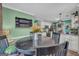The dining area features a black wooden table with chairs, and a view into the kitchen space with modern appliances at 3511 Cherry Blossom Ct, Loganville, GA 30052