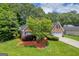 Beautifully landscaped home with a well-maintained lawn and mature trees providing ample shade at 3511 Cherry Blossom Ct, Loganville, GA 30052