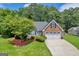 Charming home featuring a well-manicured lawn, brick accents, and an attached two-car garage at 3511 Cherry Blossom Ct, Loganville, GA 30052