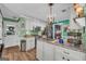 Cozy eat-in kitchen showcasing stainless appliances, light green walls, and seamless access to the living space at 3511 Cherry Blossom Ct, Loganville, GA 30052