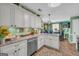 Charming eat-in kitchen with stainless steel appliances, bright green walls, and access to the breakfast nook at 3511 Cherry Blossom Ct, Loganville, GA 30052