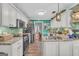 Bright kitchen featuring white cabinetry, stainless steel appliances, and eat-in area with barstool seating at 3511 Cherry Blossom Ct, Loganville, GA 30052