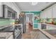 Well-lit kitchen showcasing stainless steel appliances, white cabinets, and a seamless flow into the dining area at 3511 Cherry Blossom Ct, Loganville, GA 30052