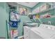 This laundry room has a washer and dryer, shelving, and is brightly lit to easily take care of any laundry needs at 3511 Cherry Blossom Ct, Loganville, GA 30052