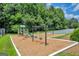 Well-maintained playground area with swings and slides with a wood chip ground cover for safety at 3511 Cherry Blossom Ct, Loganville, GA 30052