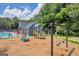 Community playground close to the pool with swings and a slide providing entertainment for residents at 3511 Cherry Blossom Ct, Loganville, GA 30052