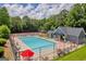 Community pool featuring lounge chairs, umbrellas, and easy access to pool house and tennis courts at 3511 Cherry Blossom Ct, Loganville, GA 30052