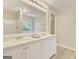 Bright bathroom featuring a double sink vanity, large mirror, and neutral paint at 1399 Cutters Mill Dr, Lithonia, GA 30058