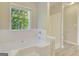 Bright bathroom features a large soaking tub, neutral paint, and a window letting in natural light at 1399 Cutters Mill Dr, Lithonia, GA 30058