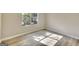 Sunlit bedroom featuring wood floors and a large window at 1399 Cutters Mill Dr, Lithonia, GA 30058