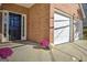 Welcoming brick front porch with a black front door and a two-car garage at 1399 Cutters Mill Dr, Lithonia, GA 30058