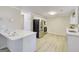 Well-appointed kitchen featuring stainless steel appliances, white cabinetry, and an eat-in breakfast bar at 1399 Cutters Mill Dr, Lithonia, GA 30058