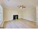 Bright living room featuring a fireplace, wood floors, and a ceiling fan at 1399 Cutters Mill Dr, Lithonia, GA 30058