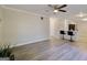 Open-concept living room with wood floors, ceiling fan, and a view of the kitchen at 1399 Cutters Mill Dr, Lithonia, GA 30058