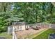 Enclosed backyard area featuring a storage shed, a trailer, and a small firepit area at 522 Golfview, Peachtree City, GA 30269