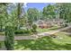 Expansive backyard featuring a pool, well-manicured lawn and a charming two-story home with a wooden deck at 522 Golfview, Peachtree City, GA 30269