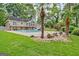 Expansive backyard with pool, slide, tropical landscaping, and a multi-level deck for outdoor entertaining at 522 Golfview, Peachtree City, GA 30269