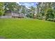 Expansive lawn with pool, slide, and a charming two-story home in a lush, green setting at 522 Golfview, Peachtree City, GA 30269