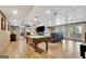 Finished basement offers a pool table, living area, wood-look floors, and access to the outdoors through French doors at 522 Golfview, Peachtree City, GA 30269