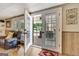 Living area featuring hardwood floors, access to outdoor patio, and a cozy seating area with a leather recliner at 522 Golfview, Peachtree City, GA 30269