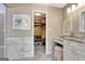 Bright bathroom featuring herringbone floors, vanity, dual sinks, and walk-in closet at 522 Golfview, Peachtree City, GA 30269