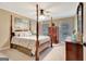 Bright bedroom featuring a four-poster bed, ceiling fan, and natural light from the windows at 522 Golfview, Peachtree City, GA 30269